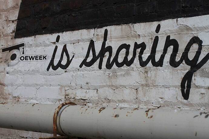 OEweek is sharing as grafitti on brick wall