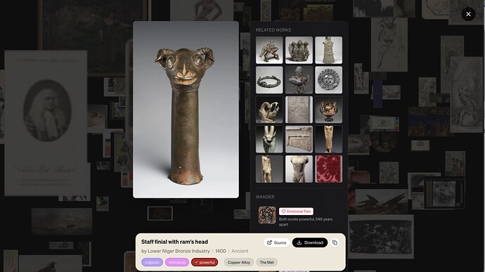 Detail of sculpture of a rams hand on the end of a rod, more art work is in background.