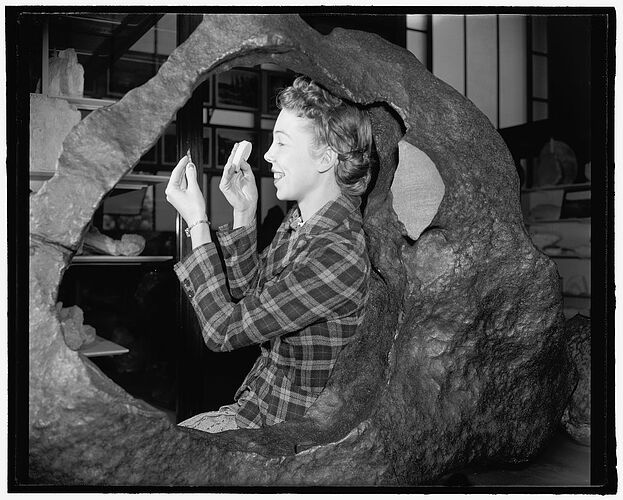 Woman posing with the Tucson Ring meteorite at the Smithsonian Museum of Natural History, Washington, D.C.