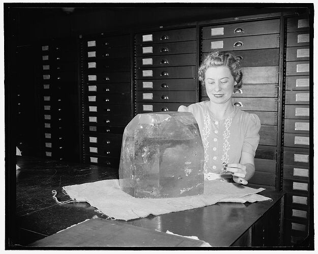 Woman with large topaz crystal from Brazil, Museum of Natural History, Smithsonian Institution, Washington, D.C.