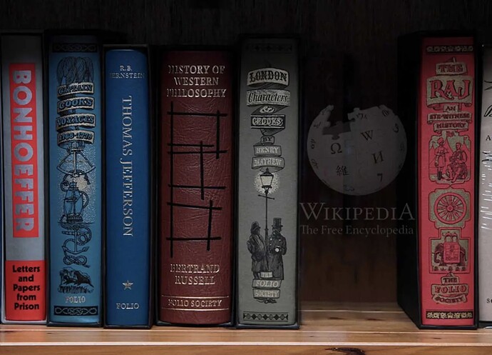 A bookshelf of old style classic books with classic embossed titles, set back and more darkened is a thicker one with the title Wikipedia on it