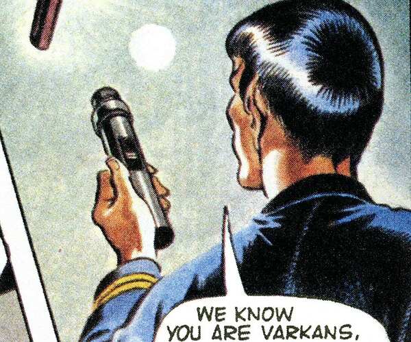 Comic book character holding a microphone with text bubble. Transcribed Text: "WE KNOW YOU ARE VARKANS"