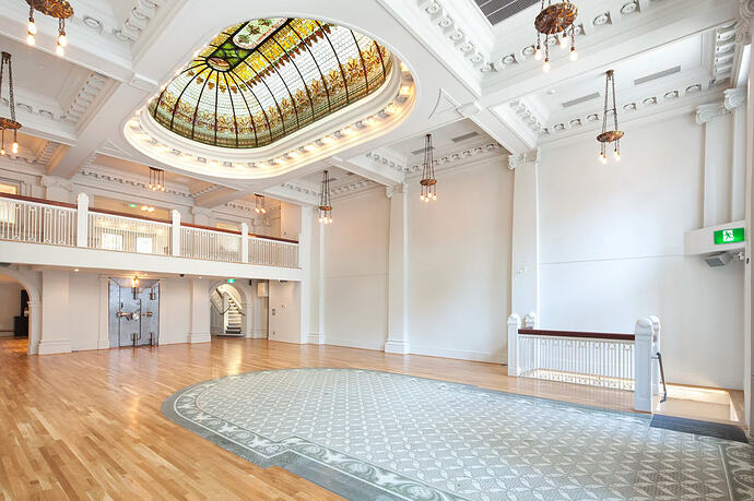 Photograph of the main hall of The Permanent, showing its distinctive mosaic tile floor and stained glass skylight.