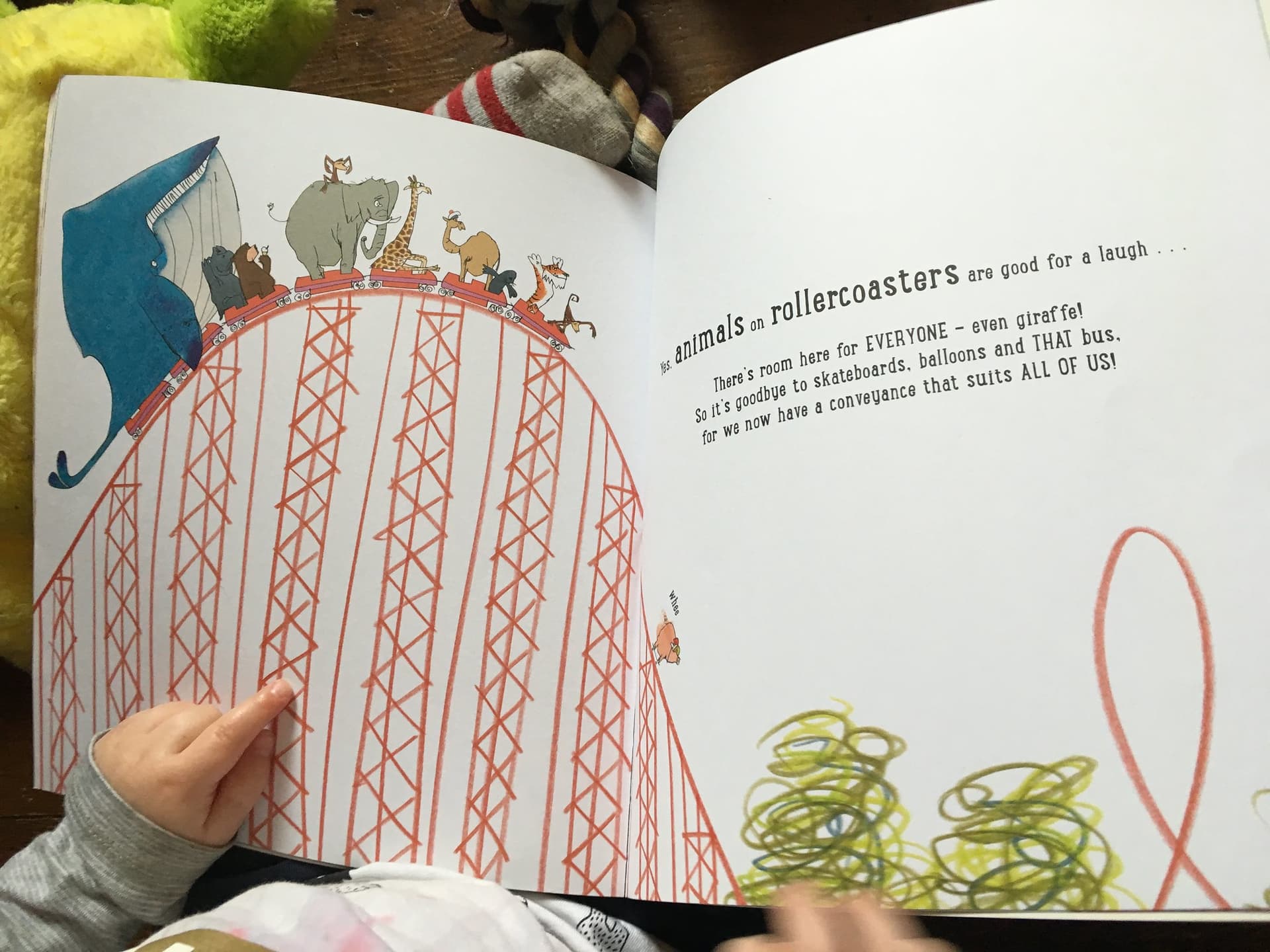 A book about animals riding a rollercoaster in the lap of a child