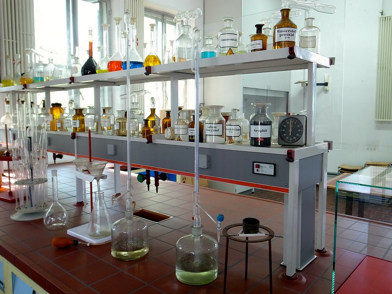 Bottles, beakers, titration instruments of a real chemistry lab, that is a metaphor!